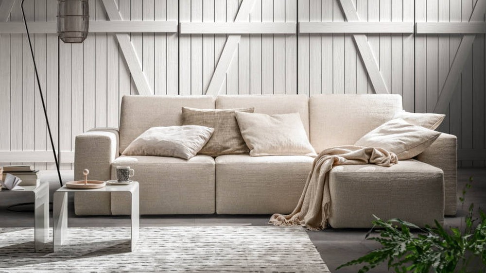 Kreminė sofa Alter su pledu jaukiame kambaryje, SAMOA DIVANI